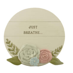 2166-13400 	Round plaque w flowers/easel-JUST BREATHE